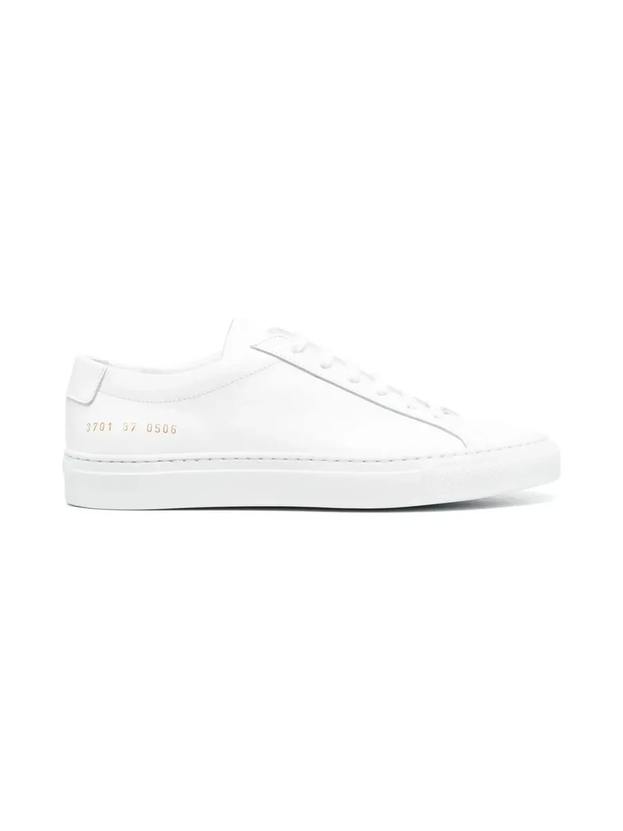White calf leather low-top sneaker with gold serial number at the heel, outer side view