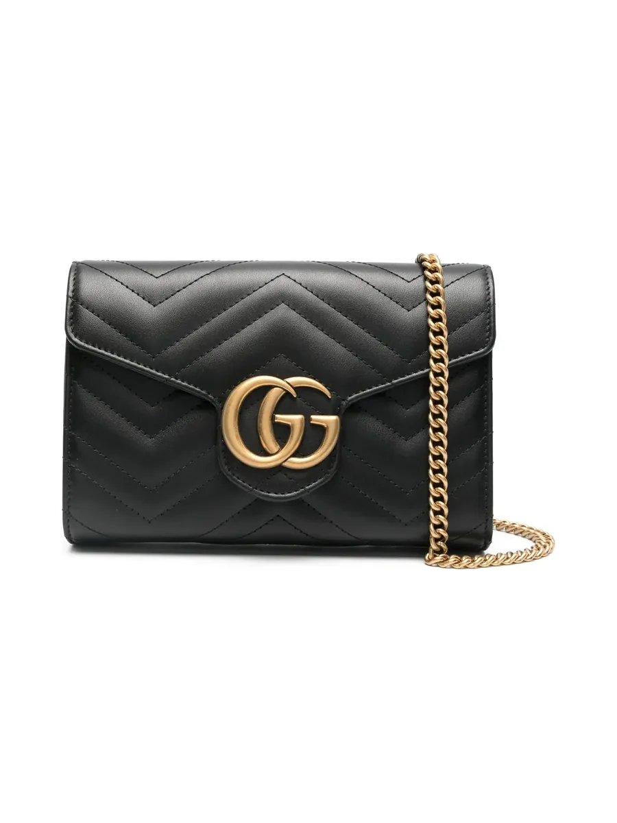 Mini black quilted leather bag with an antique gold-tone Double G plaque and chain strap, front view