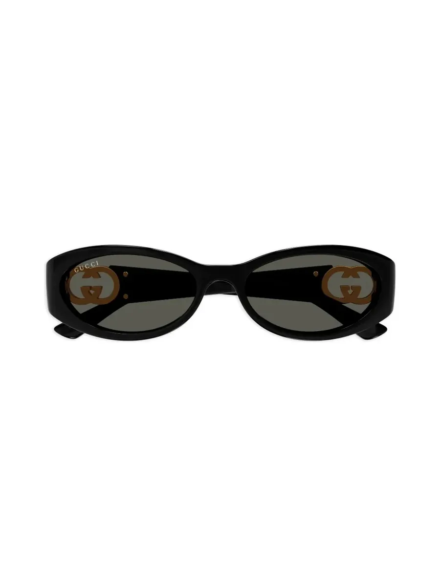 Black oval sunglasses folded, with grey lenses and the gold-tone Interlocking G at the arms