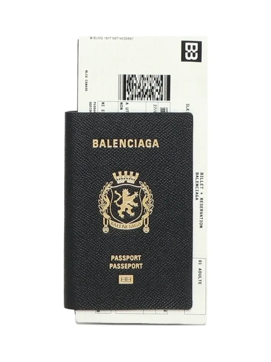 Black leather passport wallet printed in gold with a crest, with a white ticket-style insert