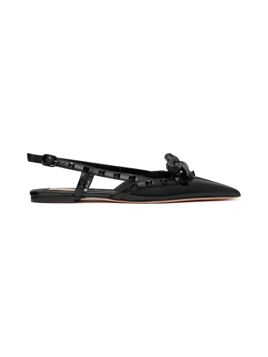 Black leather slingback ballerina with a bow and studs along the side, side view