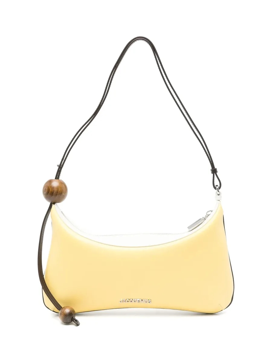 Pastel yellow curved lambskin shoulder bag with a dark brown strap and round beads, front view