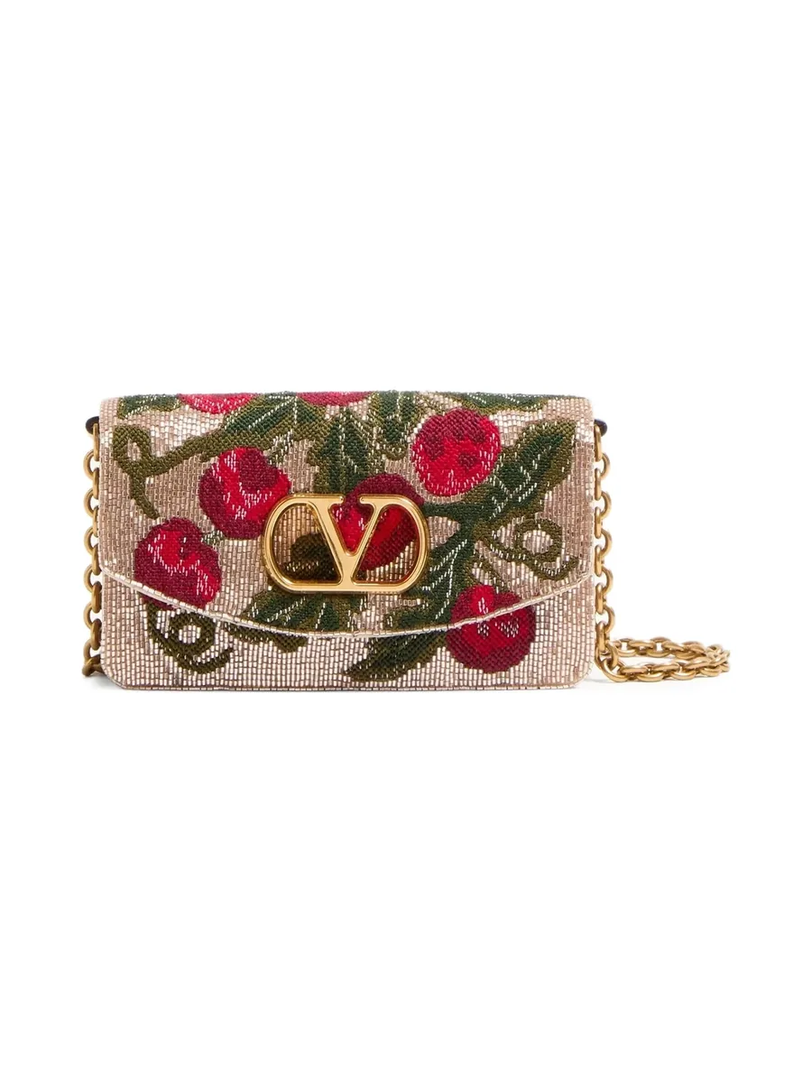Blush beige clutch embroidered with red cherries and green leaves, gold-tone V logo and chain strap