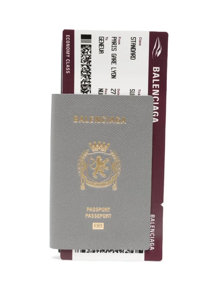 Grey leather passport wallet printed in gold with a crest, with a burgundy ticket-style insert