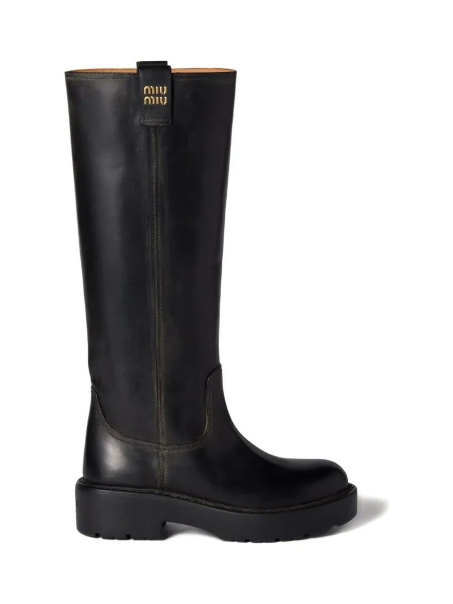 Tall black leather boot with a logo pull-tab and a chunky lug sole, side view